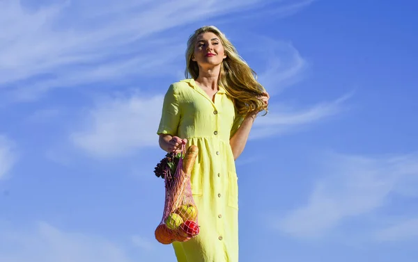 Zero waste. Plastic free concept. Reusable cotton and mesh eco bags for shopping. Girl summer day blue sky background. Eco aware. Woman carry fruits and vegetables in eco bag. Sustainable lifestyle — Stock Photo, Image