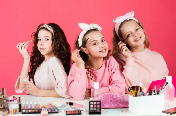 beauty and fashion. three happy girls at hairdresser. friendship and sisterhood. family bonding time. childhood happiness. retro kids put on makeup. skin care cosmetics for children. Hair like fire