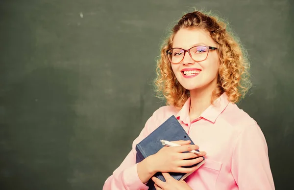 Teacher best friend of learners. Passionate about knowledge. Pedagogue hold book and explaining information. Education concept. Teacher explain hard topic. Woman school teacher in front of chalkboard