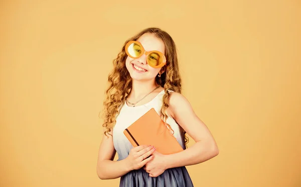 Summer fashion. small happy girl in glasses with notebook. diary notes. making plans for summer holidays and vacation. small beauty girl write her memories. reading book. workbooks for writing — Stock Photo, Image