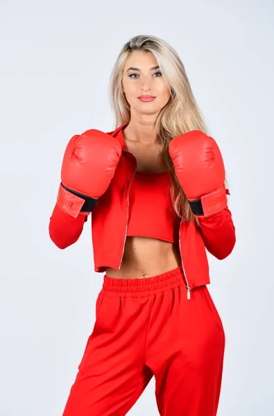 Overcome problems. Self improvement. Sporty girl red clothes boxing gloves. Gym and workout. Fitness model. Sporty lifestyle. Sporty woman fitness trainer. Personal training. Fight with own complex Stock Picture