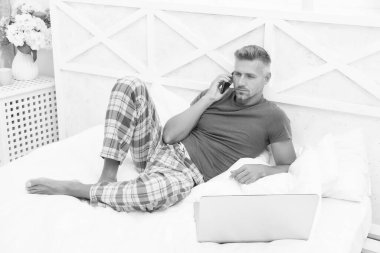 Uzaktan çalışma konsepti. Sosyal ağlar. Çevrimiçi dünya. İnternette sörf yapan adam. Dijital pazarlama. Uzaktan erişim. Olgun erkek pijaması evde rahatlayan serbest çalışan biri. Çevrimiçi hizmetler