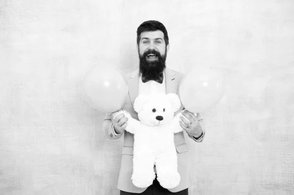 Just happy. gift with love. Stereotypical presents. Romantic man with teddy bear and party balloon. surprise for his girlfriend. holiday celebration concept. romantic man in tuxedo bow tie — Stock Photo, Image