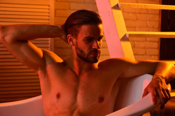 Guy in bathroom with romantic light and stairs on background