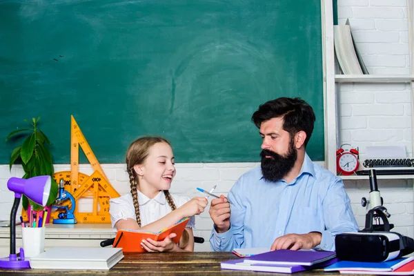 Homeschooling with father. Find buddy to help you study. Private lesson. School teacher and schoolgirl. Pedagogue skills. Talented pedagogue. Work together to accomplish more. Man bearded pedagogue