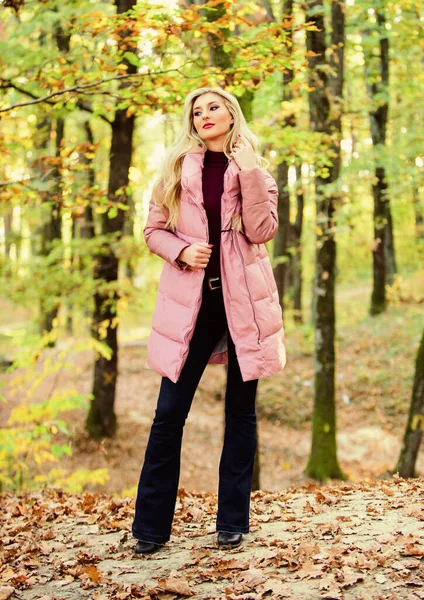 Fall fashion concept. Outfit prove puffer coat can look stylish. Jackets everyone should have. Girl fashionable blonde walk in park. Best puffer coats to buy. How to rock puffer jacket like star