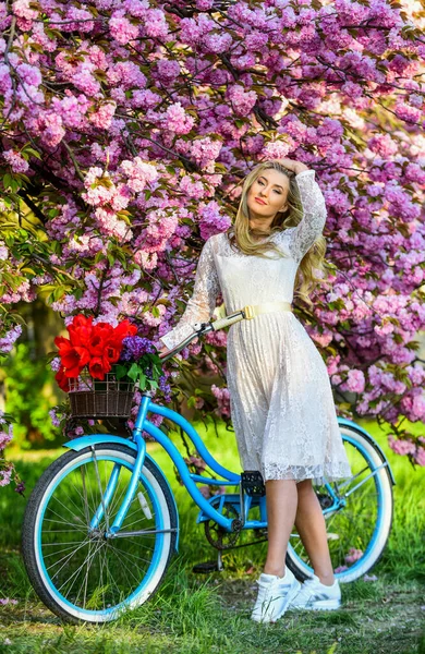 Sepetinde bahar var. Bahçedeki kadın. Kiraz çiçeklerinin yanında retro motorsikletli genç, modaya uygun bir kız. Pembe Sakura sokağında klasik bisikletli bir kız. Bahar zamanı çiçek açan ağaç. Doğal kadın güzelliği