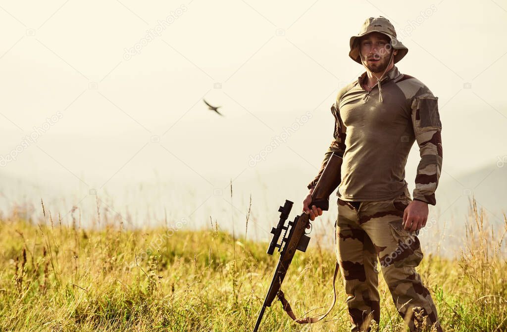 Rifle for hunting. Hunter hold rifle. Hunter mountains landscape background. Ready to shoot. Army forces. Man military clothes with weapon. Focus and concentration experienced hunter. Brutal warrior