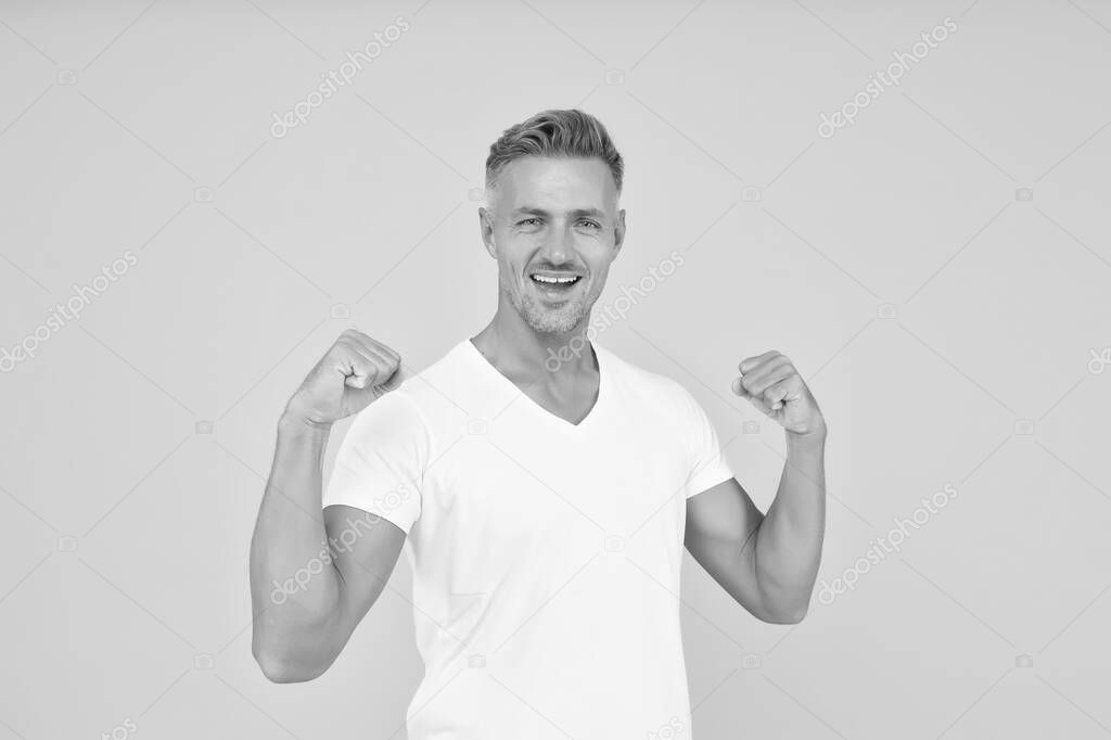 Strength and power. Happy bachelor show strength. Strong man flex arms yellow background. Strength and confident. Strength comes from within