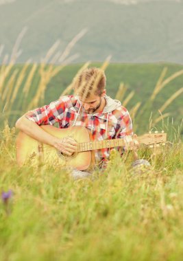 Inspiring environment. Man musician with guitar on top mountain. Inspired musician. Summer music festival outdoors. Playing music. Silence of mountains and sound of guitar strings. Hipster musician clipart