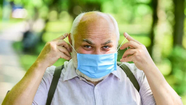 Easing of lockdown restrictions. Wear mask. Quarantine extended. Pandemic concept. Limit risk infection spreading. Senior man face mask. Mask protecting from virus. Older people highest risk covid-19