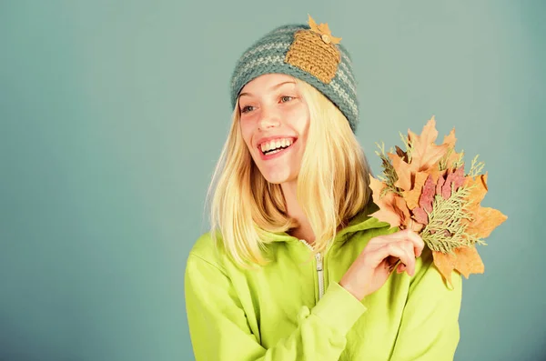 Feel happy this autumn. Woman cute face wear knitted hat hold fallen leaves. Autumn skincare tips. Skincare and beauty tips. How to update your skincare routine for autumn. Enjoy autumn season