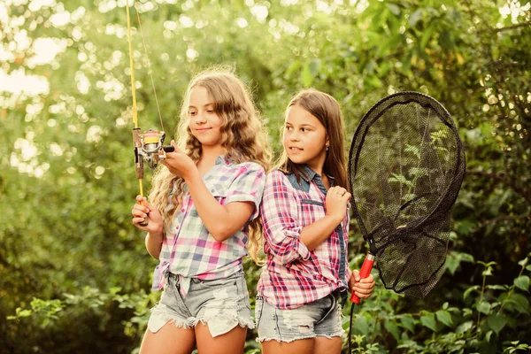 Spending good time. summer holidays weekend. Fly Fishing. little kids spend time in camp. having fun. fish angler. two girls fishing. Big game fishing. summer hobby. happy children with net and rod