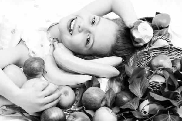 Exotic fruit or summer background with small happy girl — Stock Photo, Image