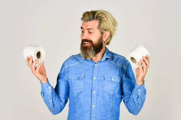 Demand more. guy suffer from diarrhea. toilet paper shortage in coronavirus panic. fear of pandemic outbreak closing shopping stores. man hold tissue roll in toilet. bearded man hold toilet paper