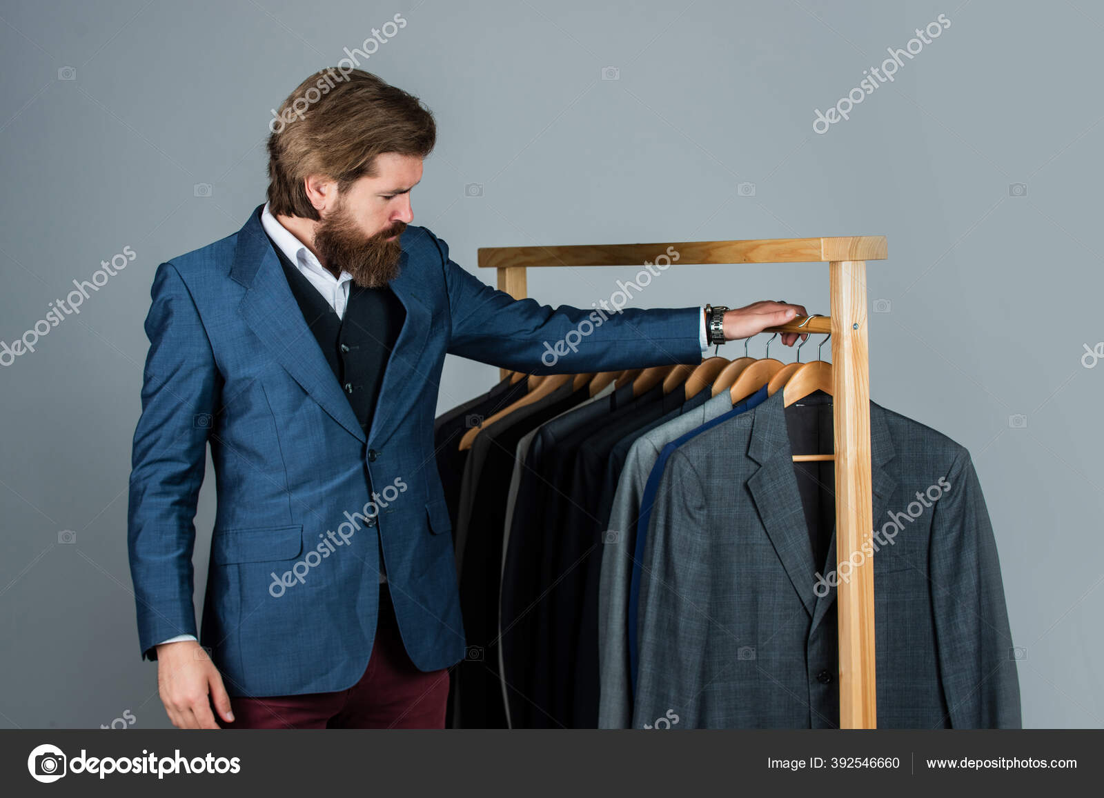 Male fashion designer. Individual measures hand of man. Man ordering  business suit posing indoor. Tailor measures man. stylish man at workspace.  Fashion design studio. Considering the next step Stock Photo by ©stetsik