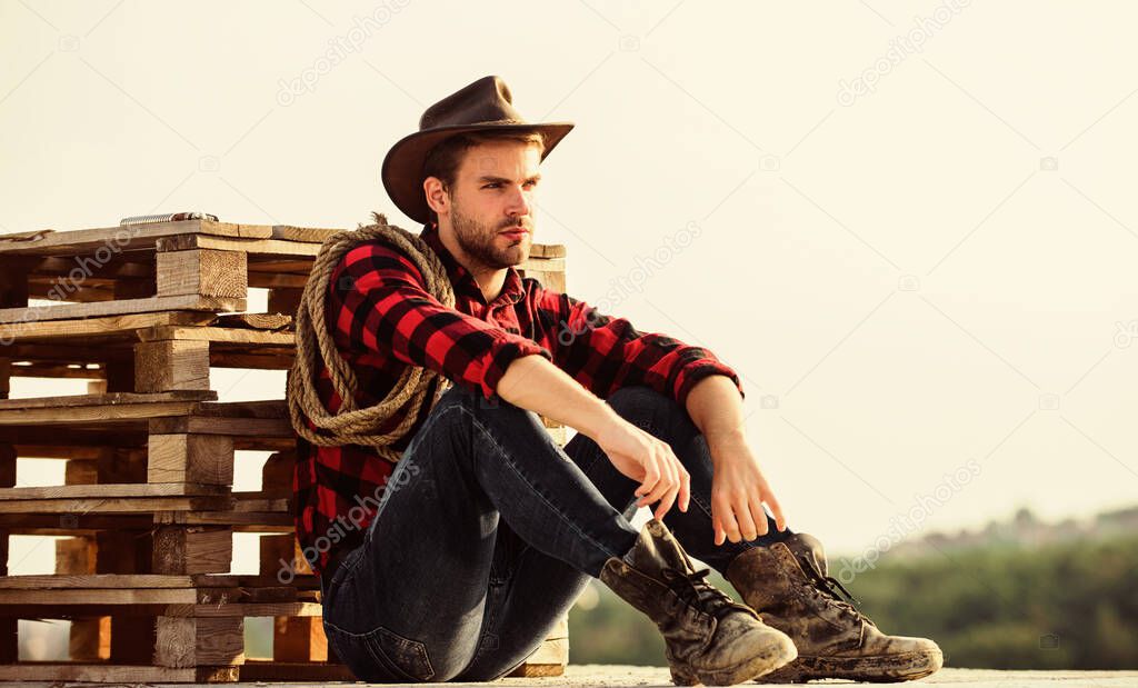 being a Texan. Vintage style man. Wild West retro cowboy. cowboy with lasso rope. Western. wild west rodeo. Thoughtful man in hat relax. western cowboy portrait. man checkered shirt on ranch