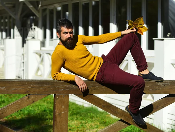 Guy with beard lies on handrail. Man with confident face — Stock Photo, Image