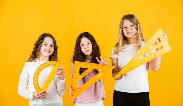 Smart and confident. exact sciences. three girls with protractor and triangle ruler. back to school. Geometry favorite subject. Education and school concept. School students learning geometry. math