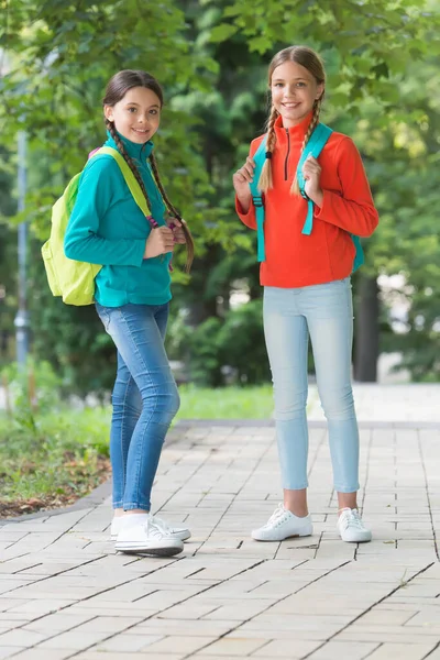 Teen kids with backpack. concept of friendship. best school friends. going to school with fun. schoolgirls with backpack. teenage girls with backpacks walking in park. Back to school — Stock Photo, Image