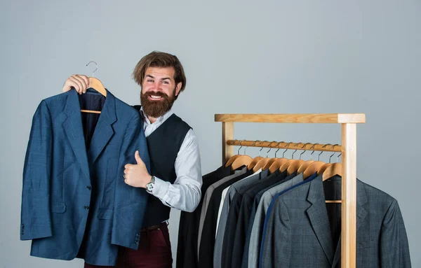 Male fashion designer. Individual measures hand of man. Man ordering business suit posing indoor. Tailor measures man. stylish man at workspace. Fashion design studio. Considering the next step — Stock Photo, Image