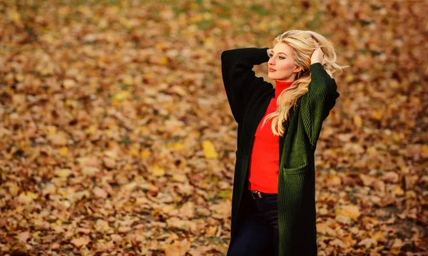 Girl fashionable blonde walk in autumn park. Long hair care concept. Cold blonde color concept. How repair bleached hair fast and safely. Autumn hair care important so as to avoid dry frizzy hair