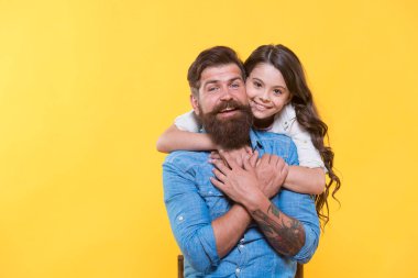 Aşk ana bileşendir. Mutlu kız babaya sevgiyle sarılıyor. Sakallı adam ve küçük çocuk. Mutlu aile sarı arka planı. İlişki ve ilişkiler. Köklü ve köklü bir aşk. Güven ve özen