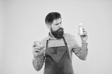 Vejetaryen beslenmesi. Meyve suyu. Taze vitamin dağıtıyorum. Hipster içeceği. Taze meyve suyu. Meyve suyu sıkıyorum. Erkek sakallı şef organik domates ve şişe sarısı arkaplan taşıyor.