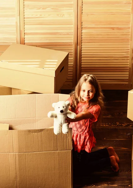 Box package and storage. Small child prepare toys for relocation. Happy childhood. Relocating family stressful for kids. Kid girl relocating boxes background. Relocating concept. Delivery service