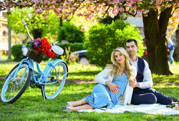 Romantic picnic. Couple cuddling on blanket. Happy together. Anniversary concept. My darling. Idyllic moment. Man and woman in love. Picnic time. Spring date. Playful couple having picnic in park