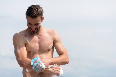 Açık gökyüzü arka planında köpükle kaplı bir adam.