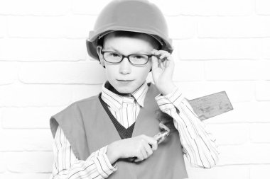 Beyaz tuğladan duvar altyapısı olan yakışıklı bir çocuk.