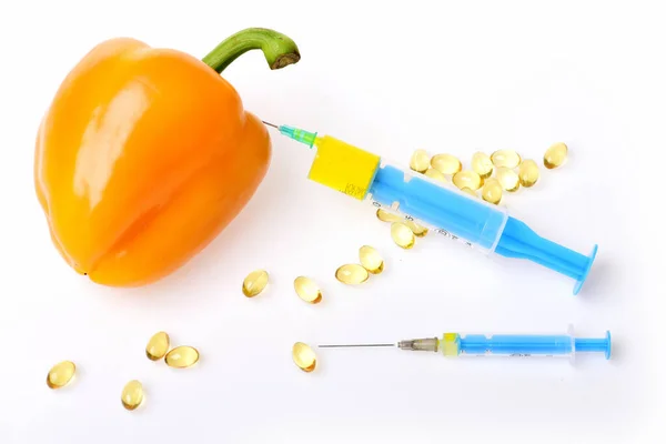 Syringes in GMO pepper and fish fat. — Stock Photo, Image