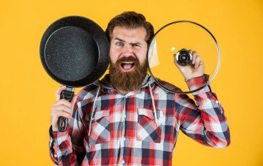 Enjoying nice weekend. brutal hipster cooking with saucepan. housekeep husband cook in pot. mature chef in checkered shirt. prepare meal food at home. professional cook. bearded man hold kitchen pan clipart