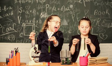 Pupils cute girls use test tubes with liquids. Chemistry experiment concept. Safety measures for providing safe chemical reaction. Basic knowledge of chemistry. Make studying chemistry interesting clipart