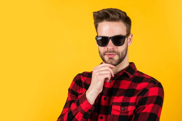 facial hair and skin care. handsome man wear checkered shirt. unshaven guy in casual style. male hairdresser and barbershop. male beauty trend. bearded man with sexy bristle in glasses. copy space