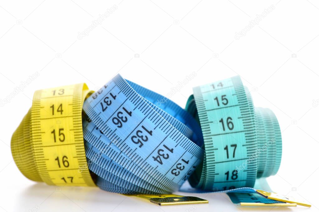 Yellow and blue rolled measuring tapes on white background.