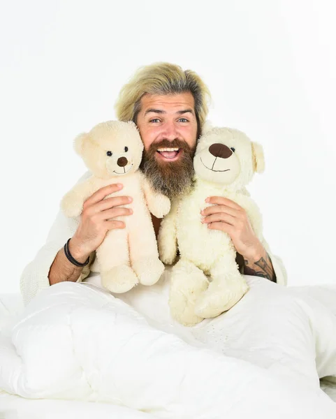 togetherness. Sick man with flu lying in the bed. sleeping at home in bed with his toy. man sleeping in embrace with white teddy bear. Handsome hipster hold lovely bear toy. Happy Valentines day