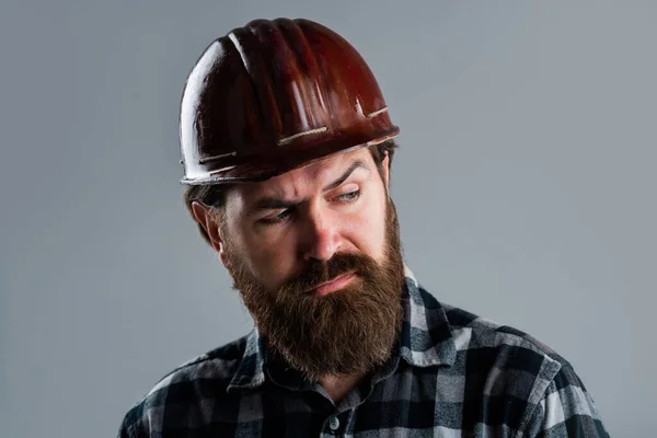serious male worker wear hard hat. brutal builder in helmet. bearded repairman. confident construction engineer. professional architect. repair and building. responsible for safety