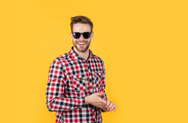 male beauty trend. bearded man with sexy bristle in glasses. facial hair and skin care. handsome man wear checkered shirt. unshaven guy in casual style. male hairdresser and barbershop. copy space