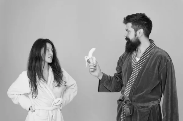 Healthy breakfast. Couple sleepy faces domestic clothes eat banana. Couple in love bathrobes. Advice relationships surviving quarantine. Morning routine. Sharing food. Healthy food. Food for health — Stock Photo, Image