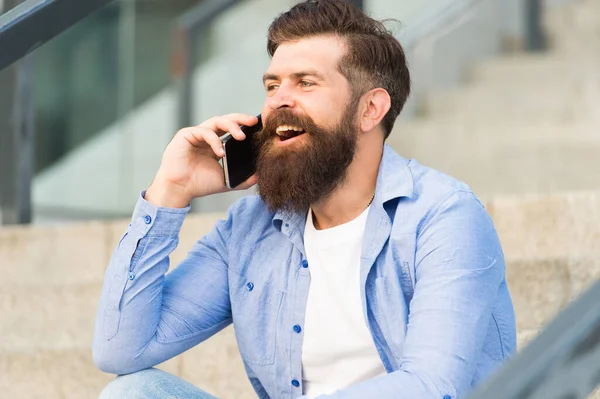 Glad to hear you again. Mobile communication. Mobile conversation. Man with smartphone urban background. Handsome man with phone outdoors. Modern life. Calling friend. Talking concept. Informing