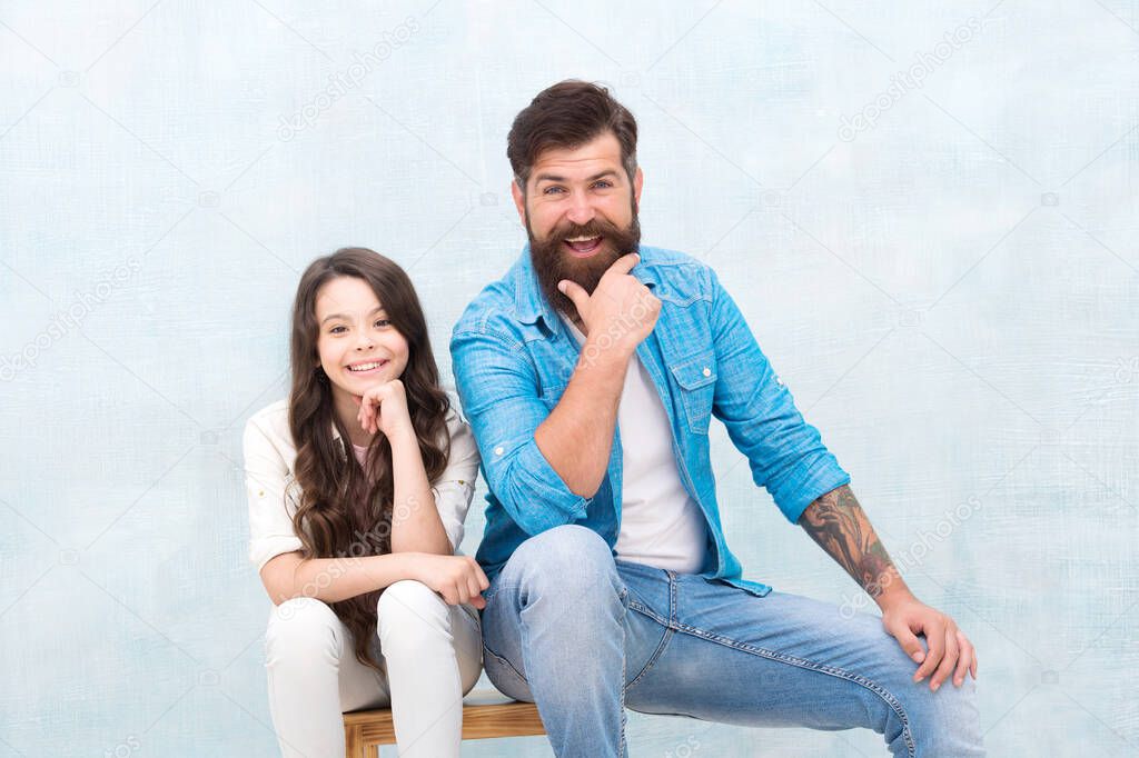 Get the best friend. Happy daughter and father sit on stool. Father child relations. Bearded man and small girl enjoy friendship. Family relations. Paternal bonds. Relations and relationship