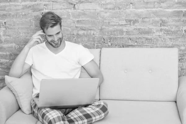 Concepto de comunicación online. Educación en casa. Compras en línea. El tipo usa un sofá relajante. Trabajo desde casa. Autoaislamiento. Quédate en casa. Distanciamiento social. Portátil de trabajo masculino. Cursos en línea — Foto de Stock