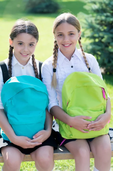 在暑期公园外面的学生们开心的笑着。拿着书包的女孩。背着背包的孩子。快乐的时光。在公园里带背包的时髦小女孩。背着背包笑的孩子 — 图库照片