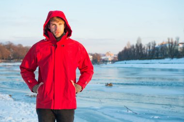 Güvenlik önlemleri. Kutup kaşifi. Kış erkek giyim. Kış kıyafeti. Rahat bir kıyafet. Sıcak ceketli, karlı bir arka plan. Kutup bölgelerinin keşfi. Kış mevsimleri. Kış balıkçılık