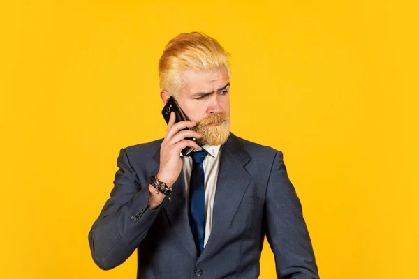 Millionaire. bearded man dyed hair wear jacket. Business people using device. Successful boss. ceo and entrepreneurship. Full concentration at work. business discussion. businessman speak on phone