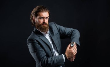 watch repair. serious bearded man. handsome and successful man in expensive suit. He in shirt with hand watch. stylish successful man in suit posing. business man wear suit. official office lifestyle clipart