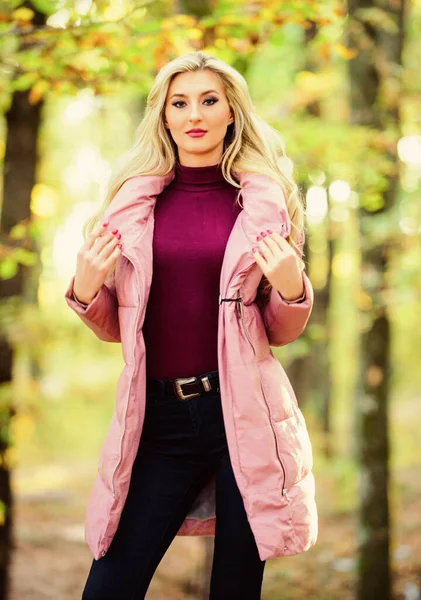 Girl fashionable blonde walk in park. Best puffer coats to buy. How to rock puffer jacket like star. Fall fashion concept. Outfit prove puffer coat can look stylish. Jackets everyone should have