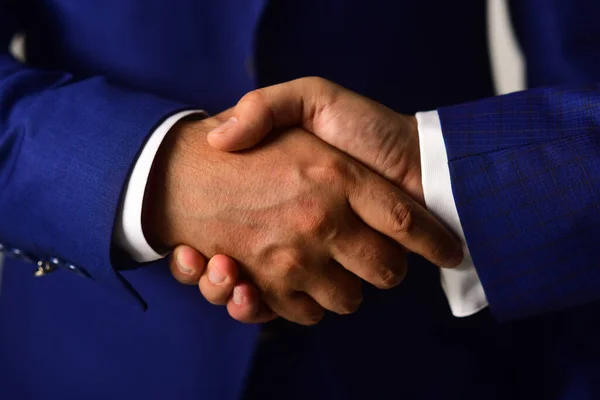 Male hands shaking tight. Handshake on light grey background — Stock Photo, Image